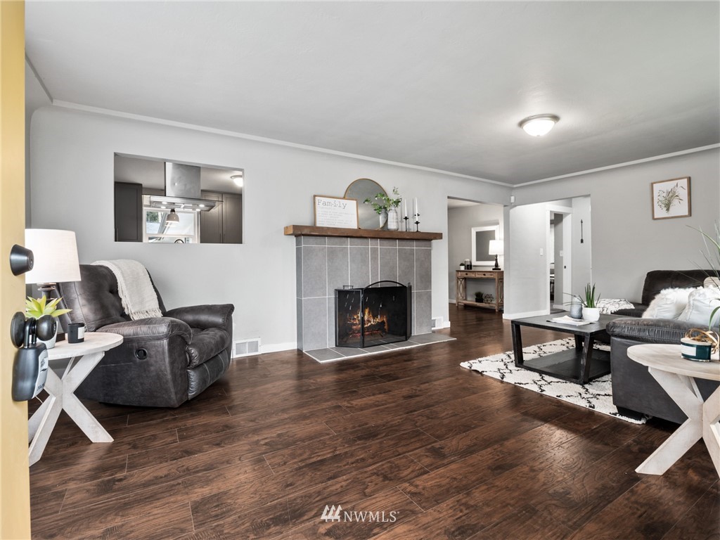 10222 Golden Given Road East Tacoma, WA 98445 - Photo 4 of 23 a living room with furniture and a fireplace