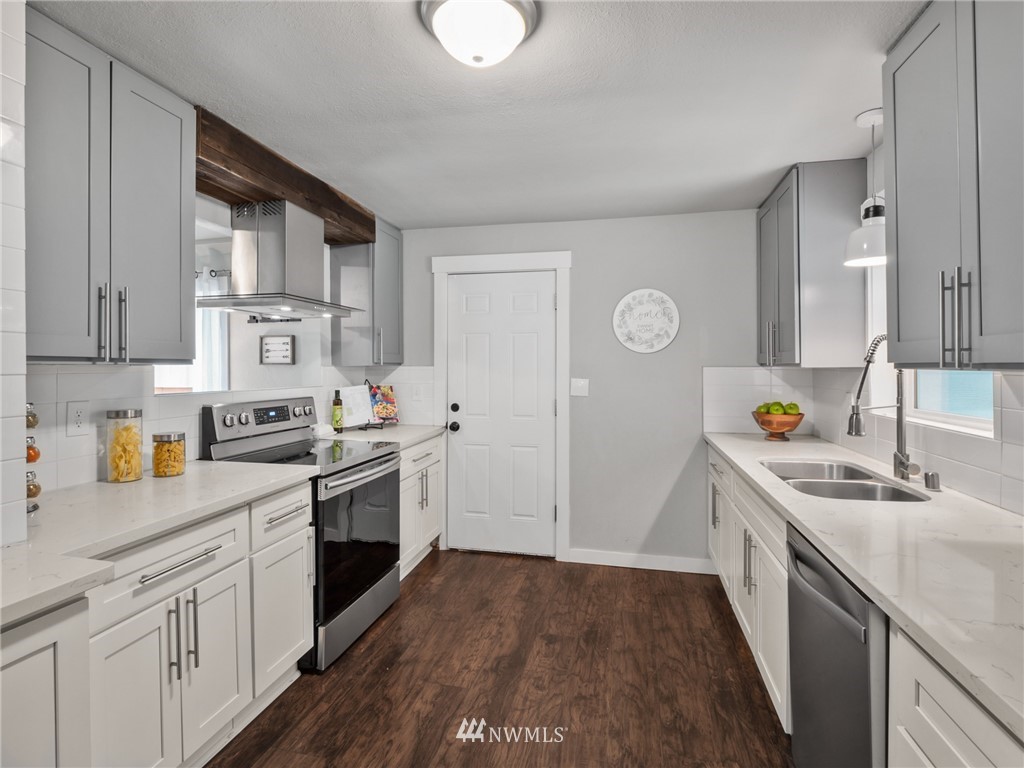 10222 Golden Given Road East Tacoma, WA 98445 - Photo 5 of 23 a kitchen with stainless steel appliances granite countertop a sink and cabinets