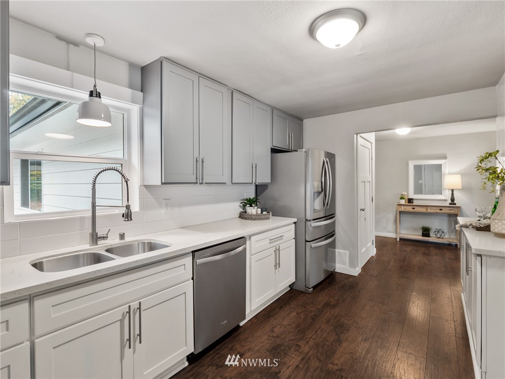 10222 Golden Given Road East Tacoma, WA 98445 - Photo 6 of 23 a kitchen with a sink stainless steel appliances and cabinets