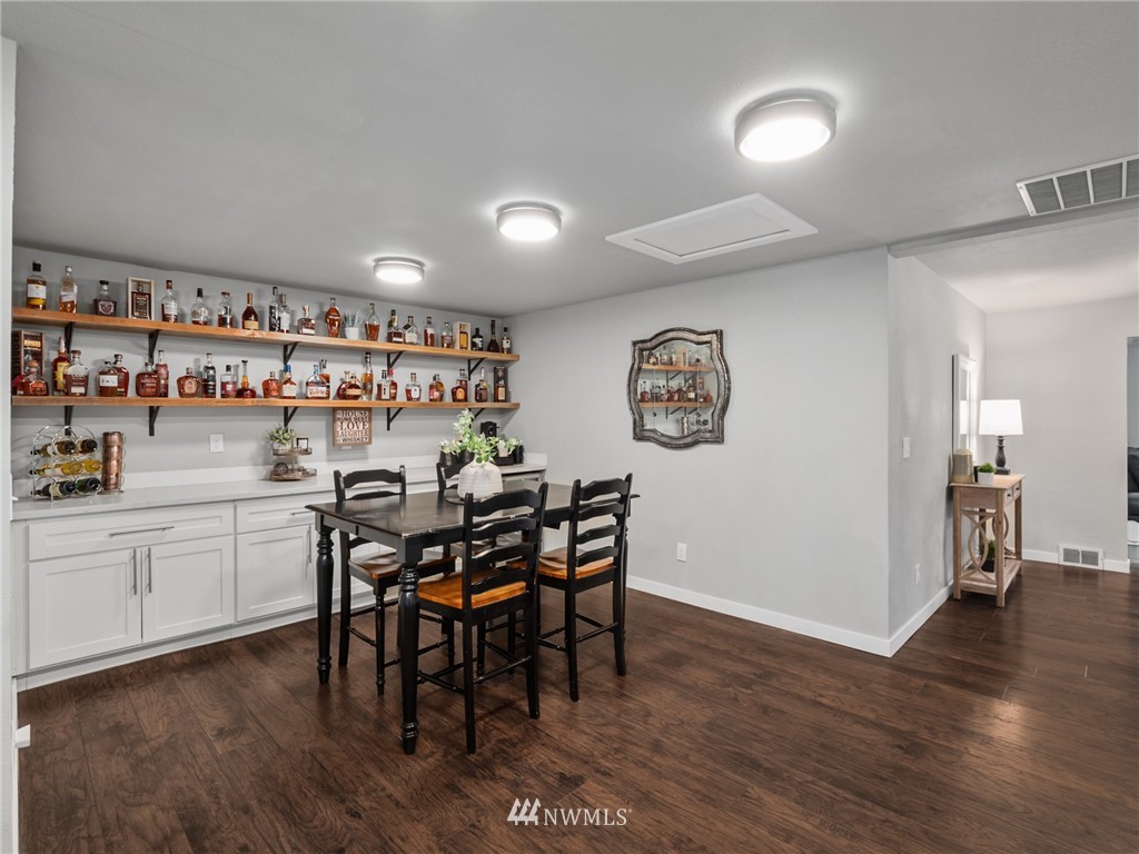10222 Golden Given Road East Tacoma, WA 98445 - Photo 7 of 23 a view of a dining room with furniture and wooden floor