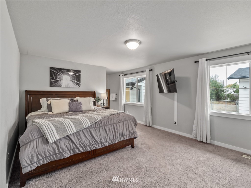 10222 Golden Given Road East Tacoma, WA 98445 - Photo 10 of 23 a bedroom with a bed closet and a window