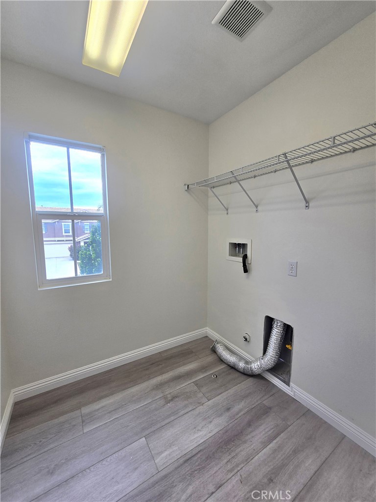 3073 Snowdrop Court Perris, CA 92571 - Photo 11 of 25 a view of a room with wooden floor and windows