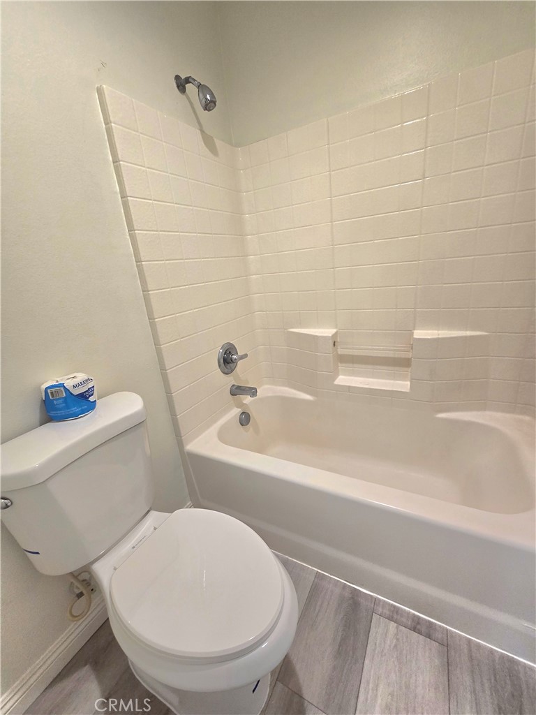 3073 Snowdrop Court Perris, CA 92571 - Photo 14 of 25 a white toilet sitting next to a bath tub