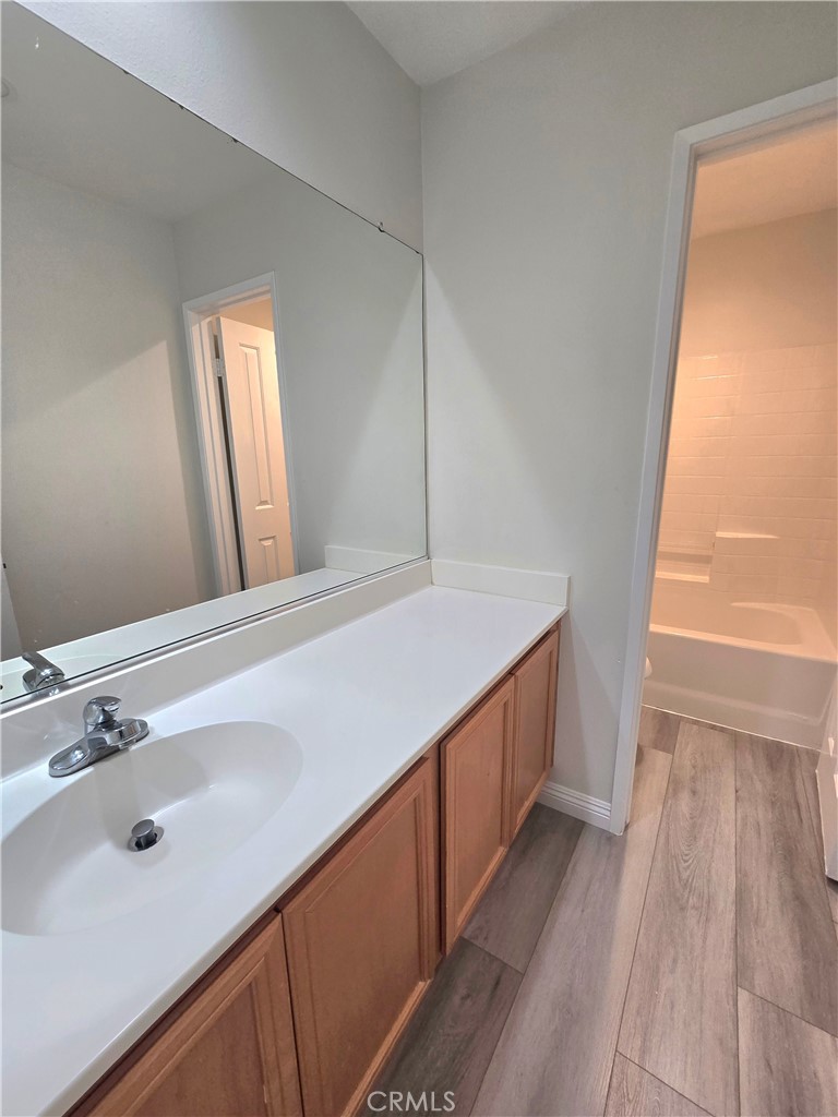 3073 Snowdrop Court Perris, CA 92571 - Photo 15 of 25 a bathroom with a double vanity sink and a mirror
