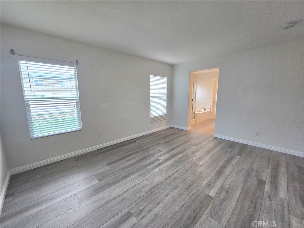3073 Snowdrop Court Perris, CA 92571 - Photo 20 of 25 a view of an empty room with wooden floor and a window
