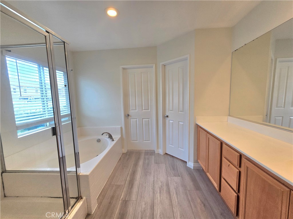 3073 Snowdrop Court Perris, CA 92571 - Photo 21 of 25 a bathroom with a bathtub and a shower