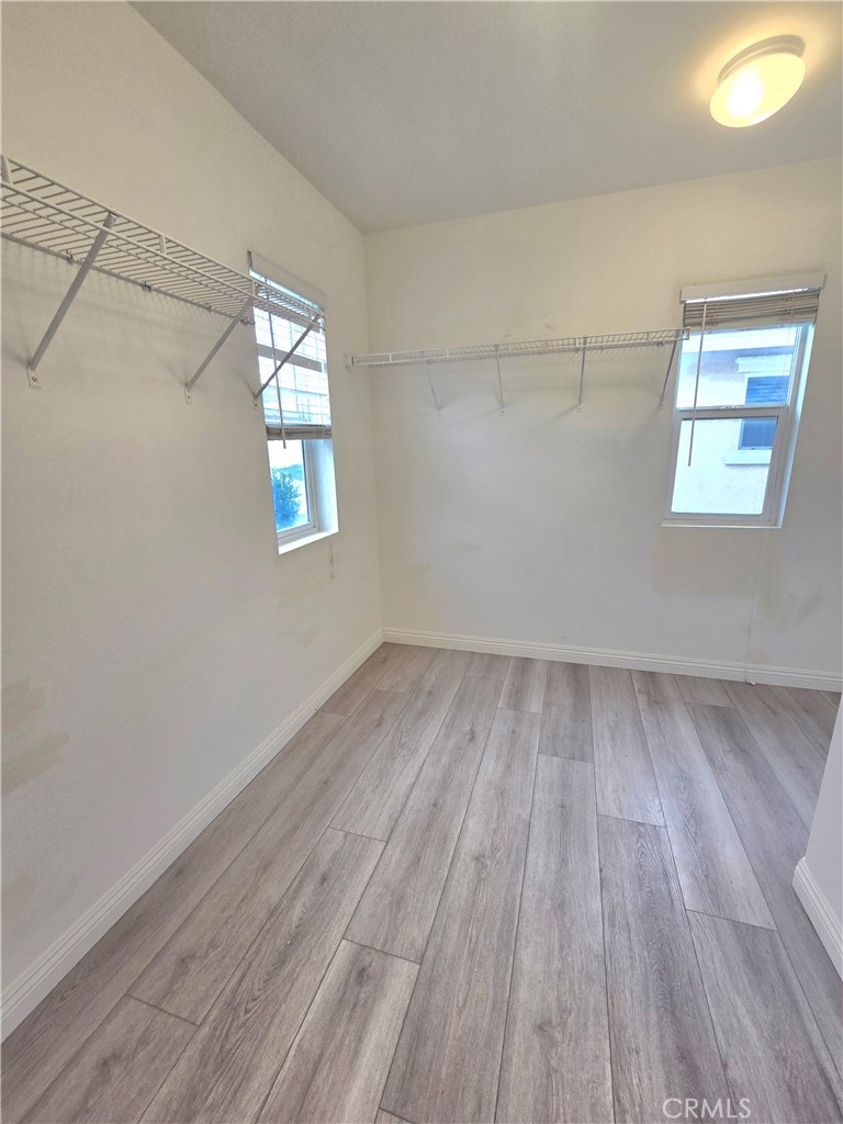 3073 Snowdrop Court Perris, CA 92571 - Photo 22 of 25 an empty room with wooden floor and windows