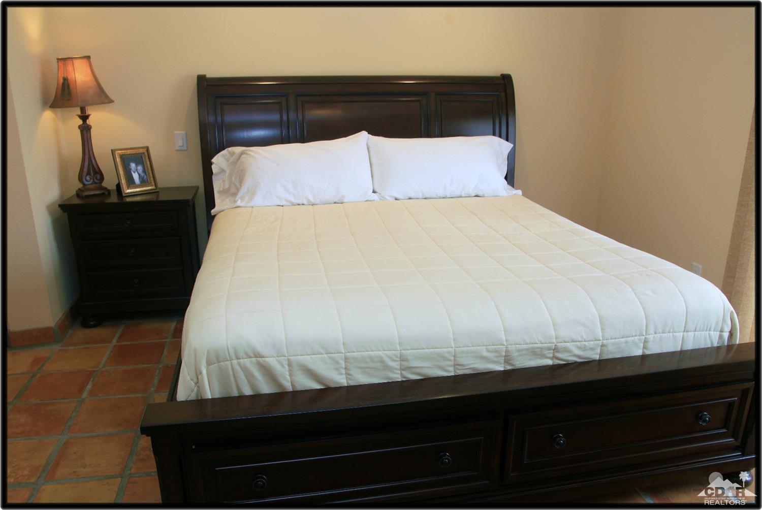 42872 Scirocco Road Palm Desert, CA 92211 - Photo 13 of 23 a bed sitting in a bedroom with a night stand
