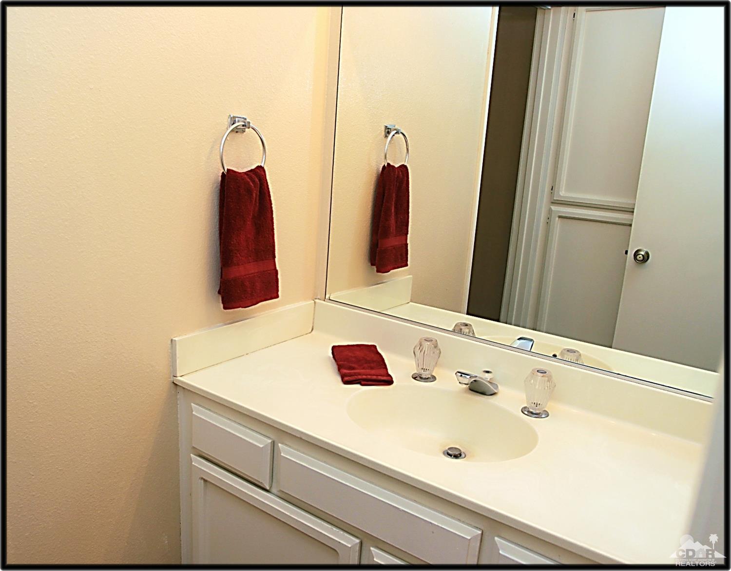 42872 Scirocco Road Palm Desert, CA 92211 - Photo 17 of 23 a bathroom with a sink and a mirror