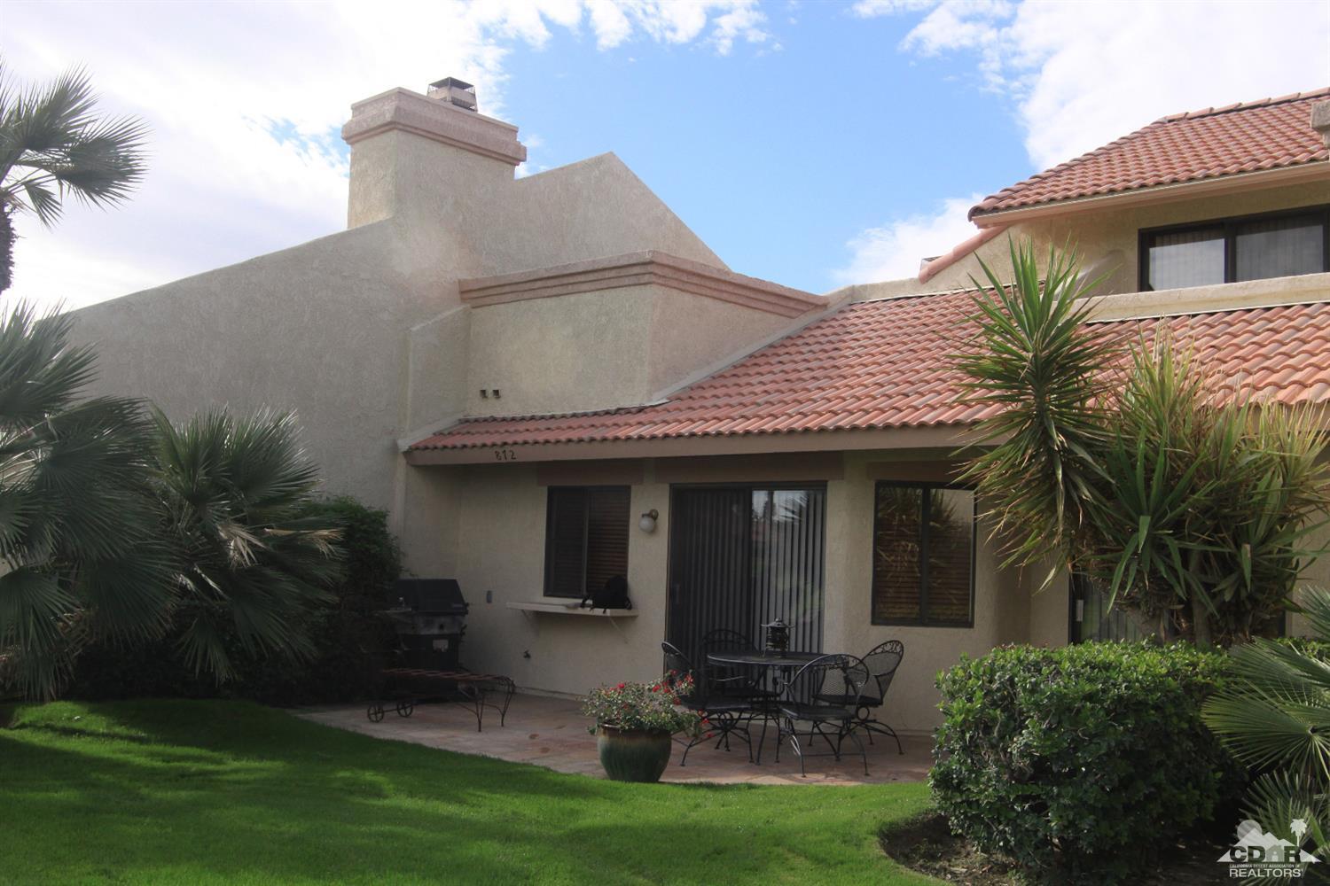 42872 Scirocco Road Palm Desert, CA 92211 - Photo 19 of 23 a view of a chair and table in patio next to a yard