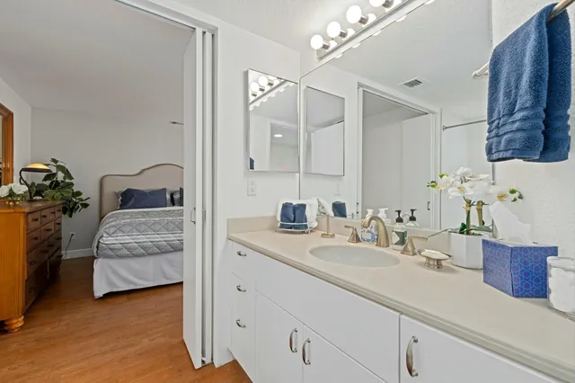 a bedroom with a bed and wooden floor