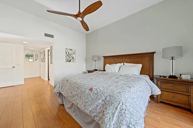 a view of a house with a big yard and palm trees