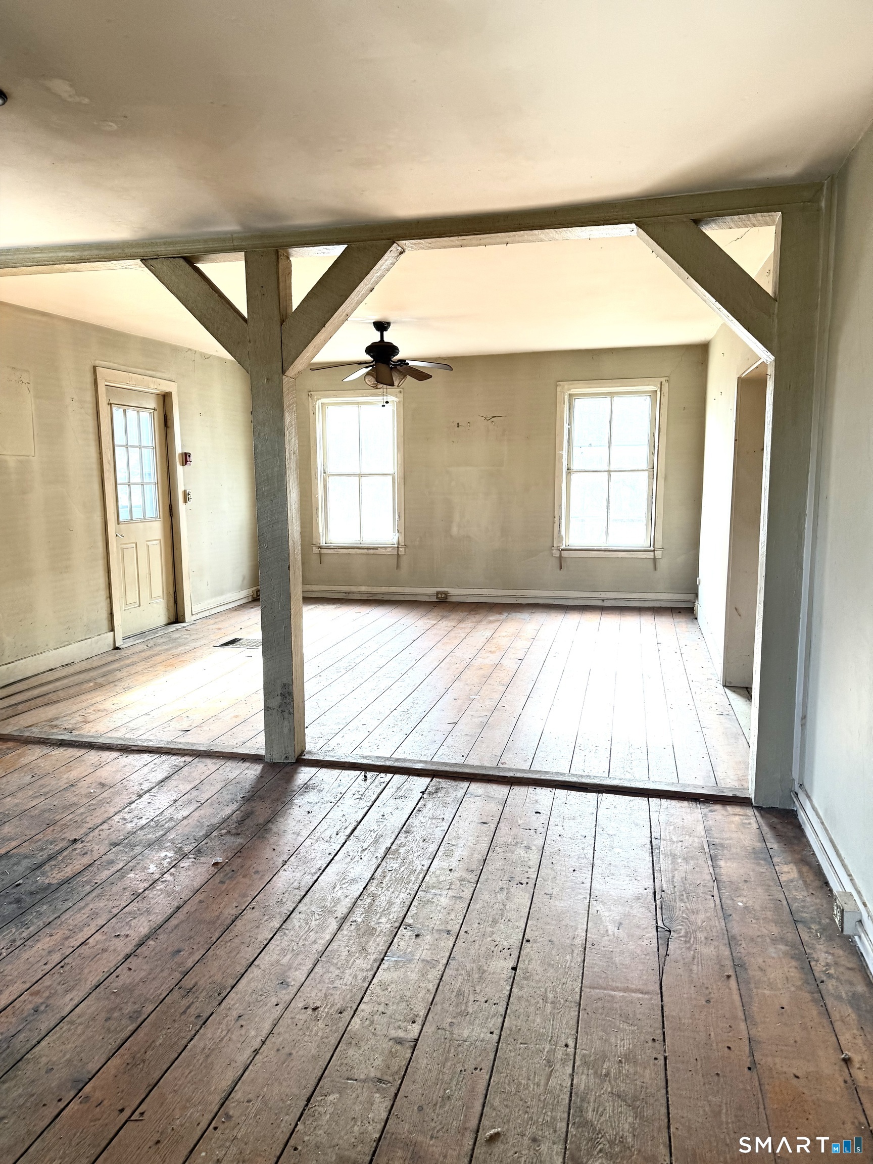7 Baltic Road Franklin, CT 06254 - Photo 11 of 26 an empty room with wooden floor and windows