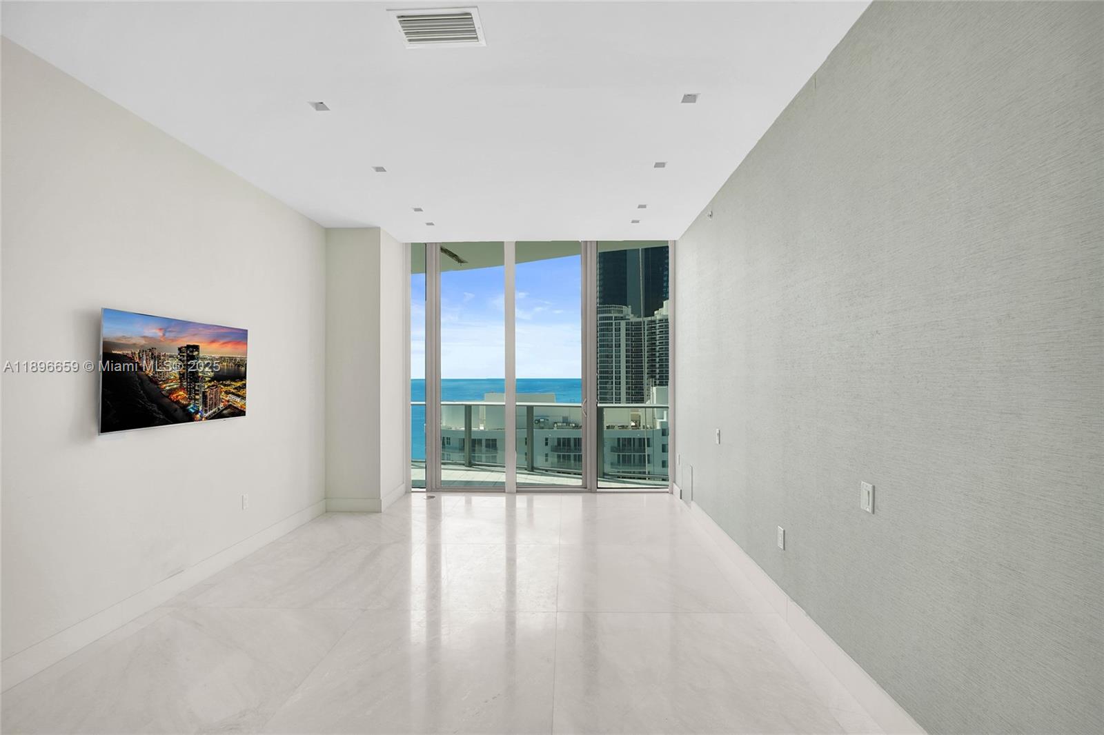 17475 Collins Avenue, Unit 2302 Sunny Isles Beach, FL 33160 - Photo 11 of 42 a view of an empty room with a window