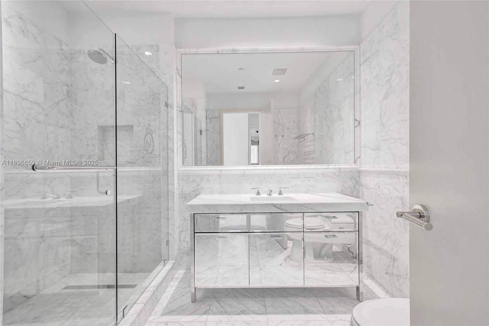 17475 Collins Avenue, Unit 2302 Sunny Isles Beach, FL 33160 - Photo 12 of 42 a bathroom with a sink and a mirror