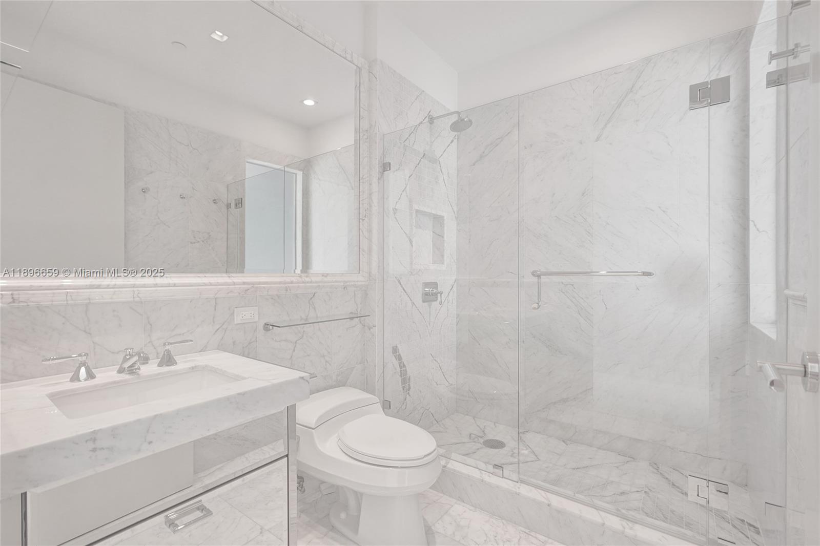 17475 Collins Avenue, Unit 2302 Sunny Isles Beach, FL 33160 - Photo 16 of 42 a bathroom with a sink a toilet and shower