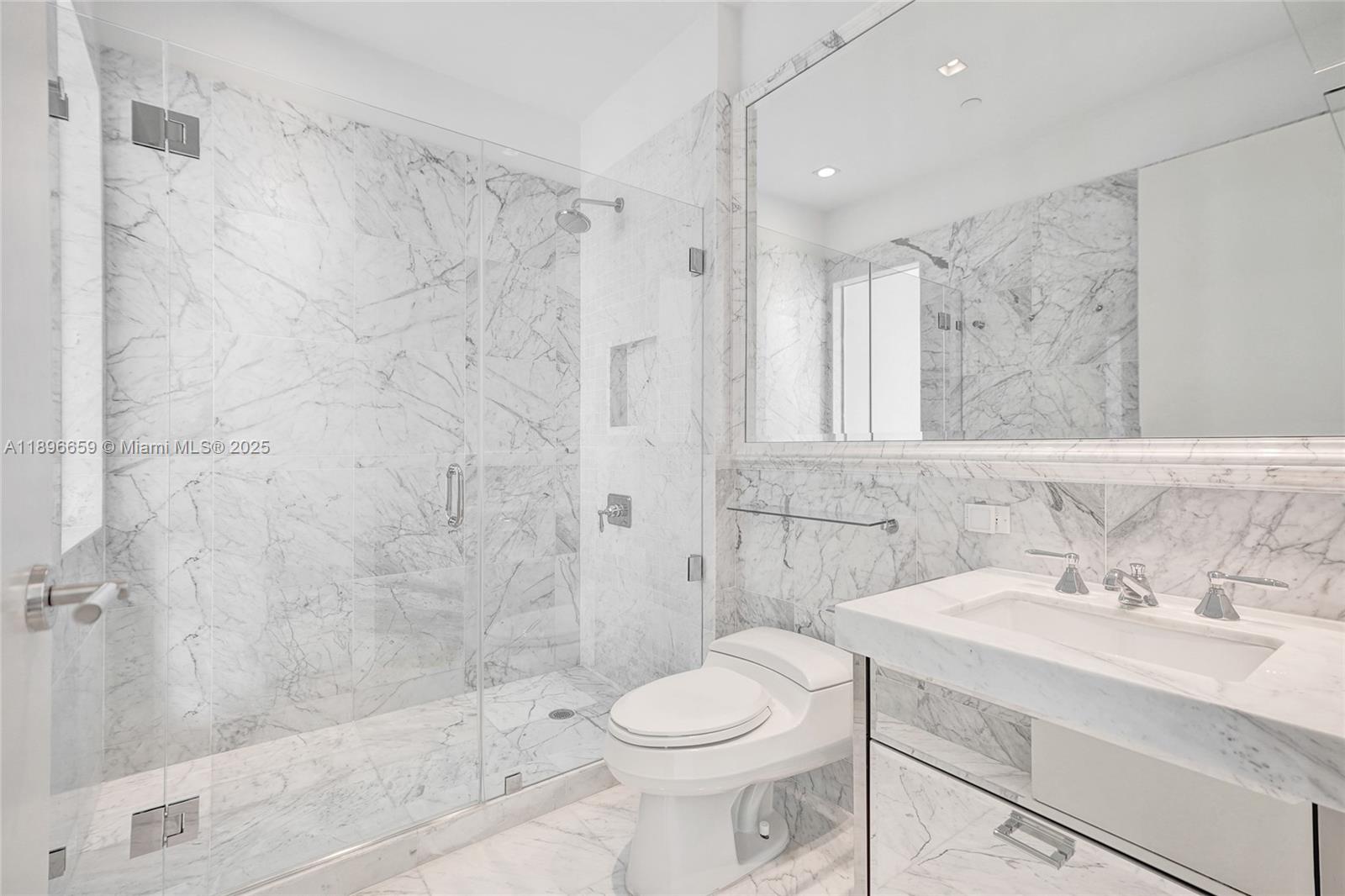 17475 Collins Avenue, Unit 2302 Sunny Isles Beach, FL 33160 - Photo 19 of 42 a bathroom with a sink toilet and shower