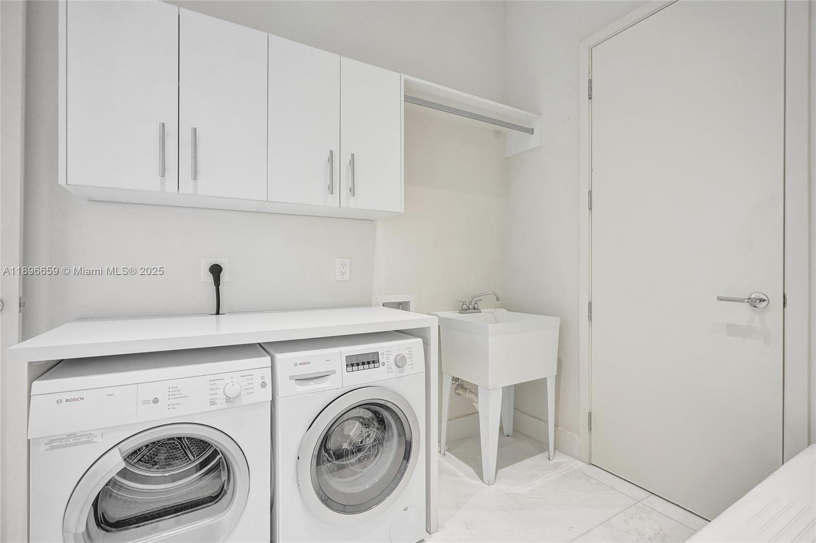 17475 Collins Avenue, Unit 2302 Sunny Isles Beach, FL 33160 - Photo 21 of 42 a utility room with dryer and washer