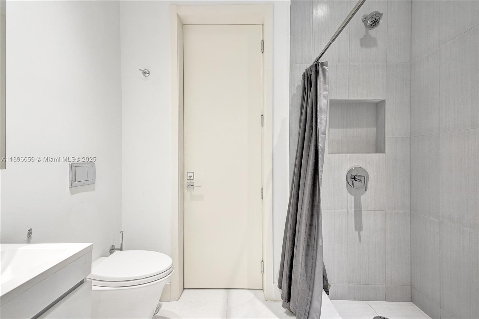 17475 Collins Avenue, Unit 2302 Sunny Isles Beach, FL 33160 - Photo 22 of 42 a bathroom with a toilet a sink and shower