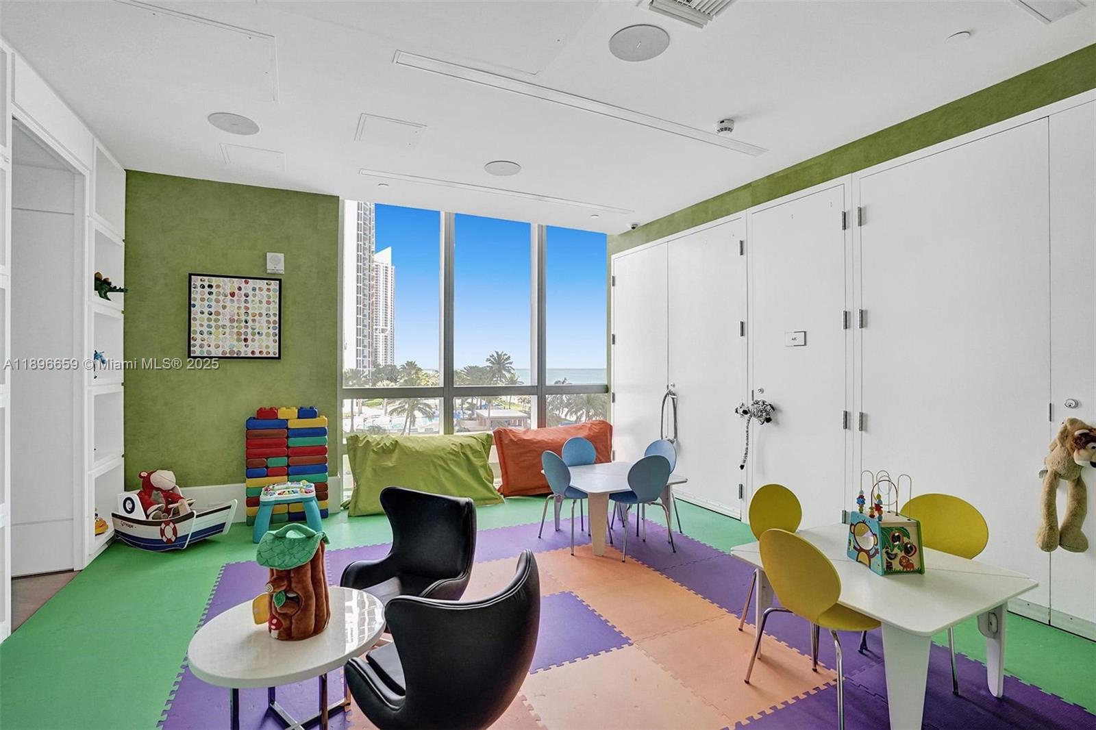 17475 Collins Avenue, Unit 2302 Sunny Isles Beach, FL 33160 - Photo 37 of 42 a living room with furniture and a floor to ceiling window