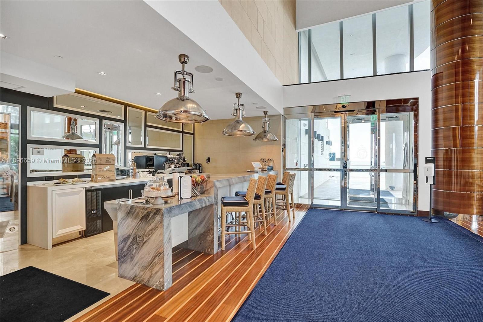 17475 Collins Avenue, Unit 2302 Sunny Isles Beach, FL 33160 - Photo 38 of 42 a view of a kitchen with furniture and a window