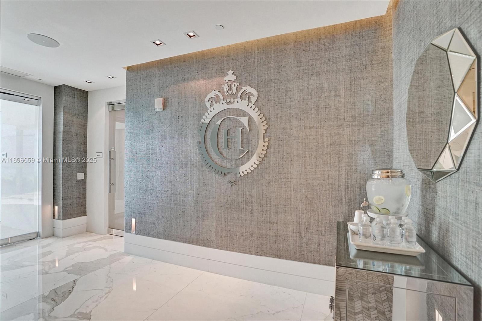 17475 Collins Avenue, Unit 2302 Sunny Isles Beach, FL 33160 - Photo 40 of 42 a bathroom with a sink a mirror and shower