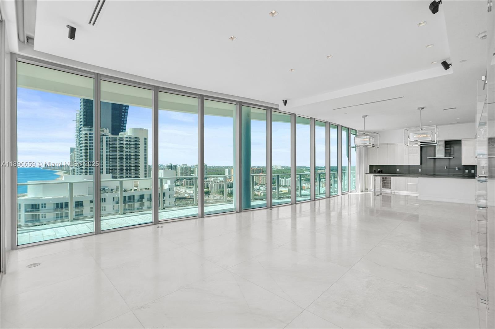 17475 Collins Avenue, Unit 2302 Sunny Isles Beach, FL 33160 - Photo 6 of 42 a view of an entryway with floor to ceiling windows in an empty room