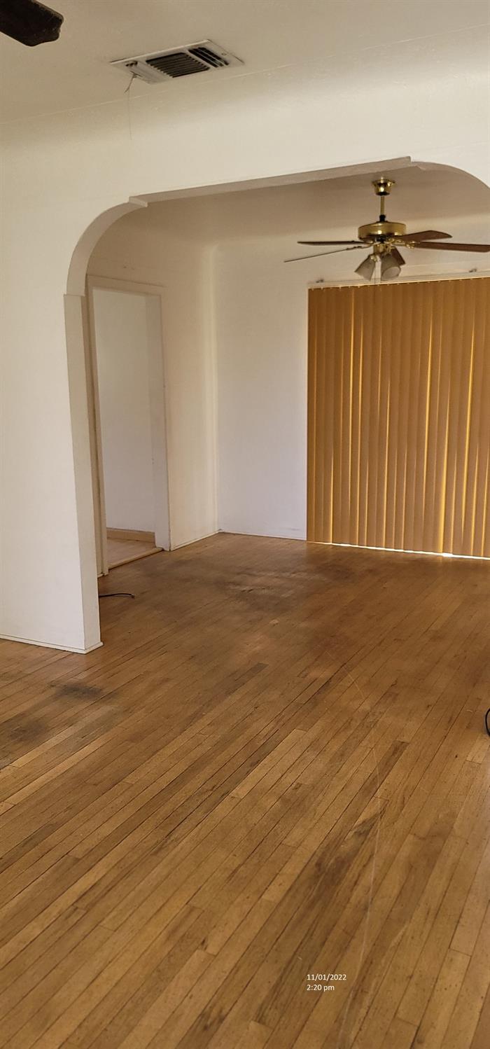 987 South Rupert Avenue Reedley, CA 93654 - Photo 8 of 20 a view of an empty room with wooden floor
