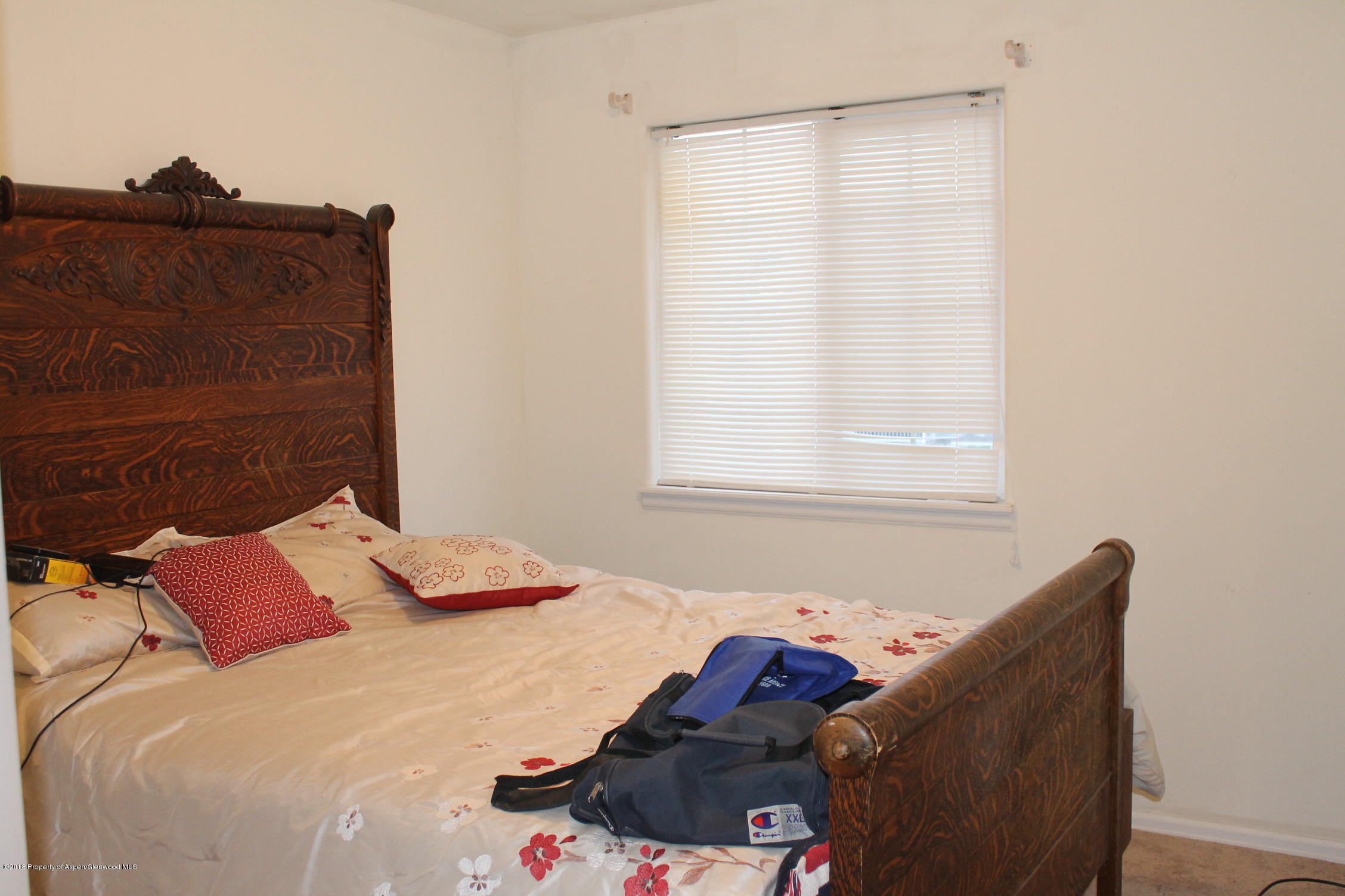 402 Columbine Court Rifle, CO 81650 - Photo 12 of 19 a bedroom with a bed and window
