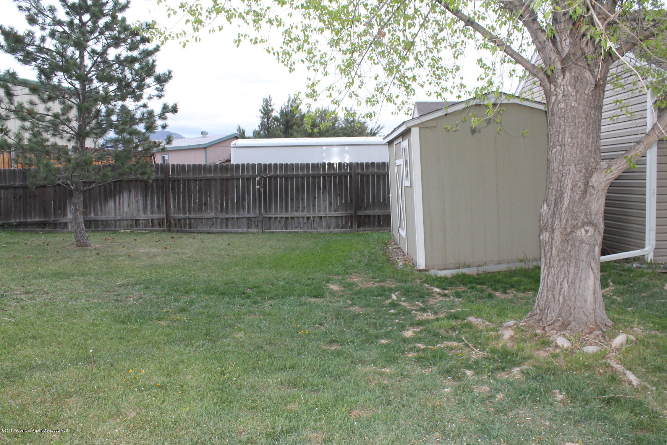 402 Columbine Court Rifle, CO 81650 - Photo 17 of 19 a backyard of a house with lots of green space