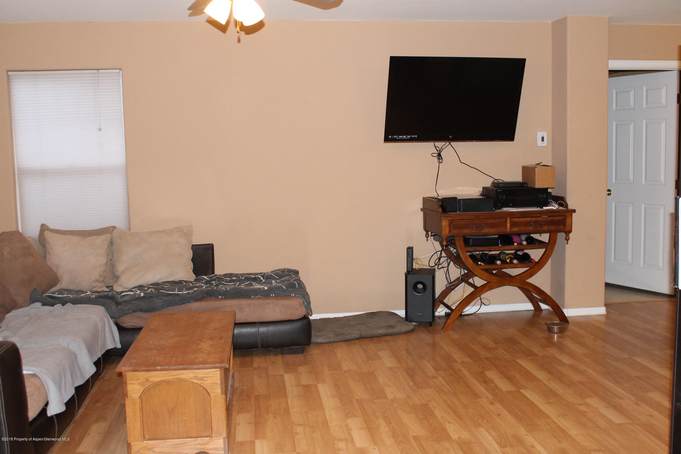 402 Columbine Court Rifle, CO 81650 - Photo 3 of 19 a bedroom with a bed and a flat screen tv