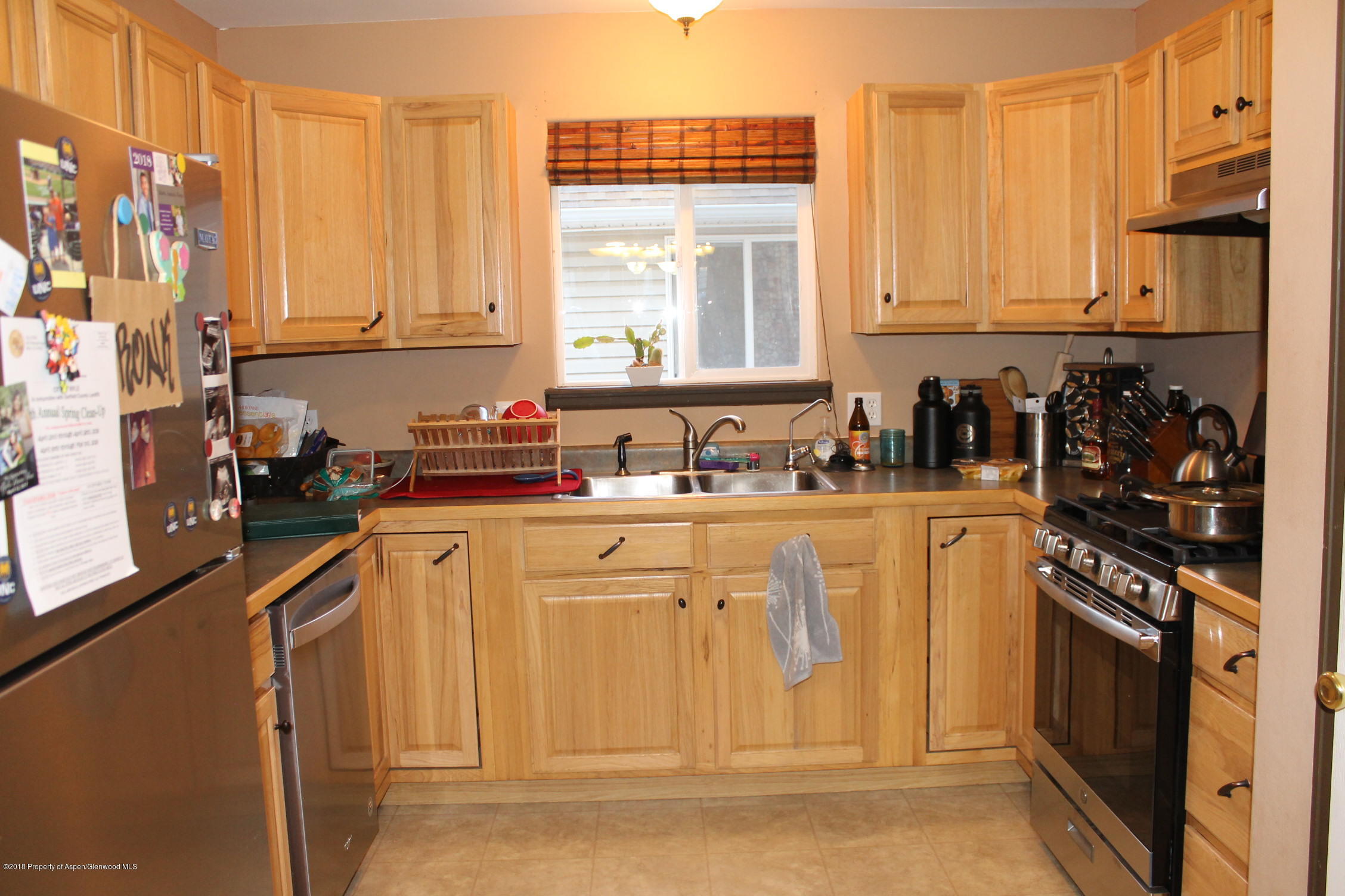 402 Columbine Court Rifle, CO 81650 - Photo 8 of 19 a kitchen with stainless steel appliances granite countertop a refrigerator sink and cabinets
