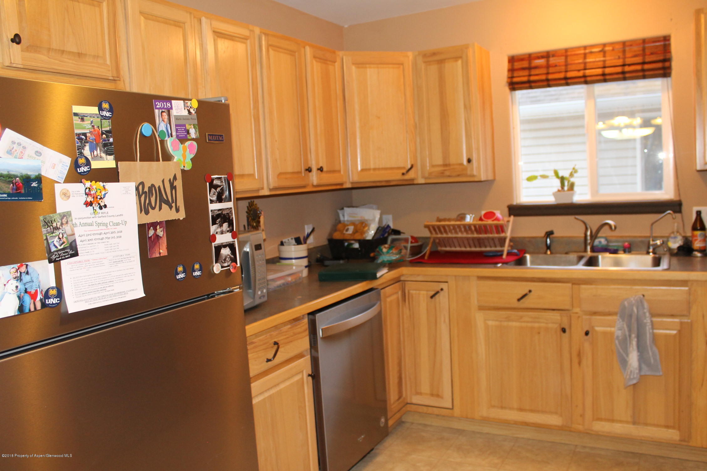 402 Columbine Court Rifle, CO 81650 - Photo 9 of 19 a kitchen with stainless steel appliances granite countertop a refrigerator and a sink