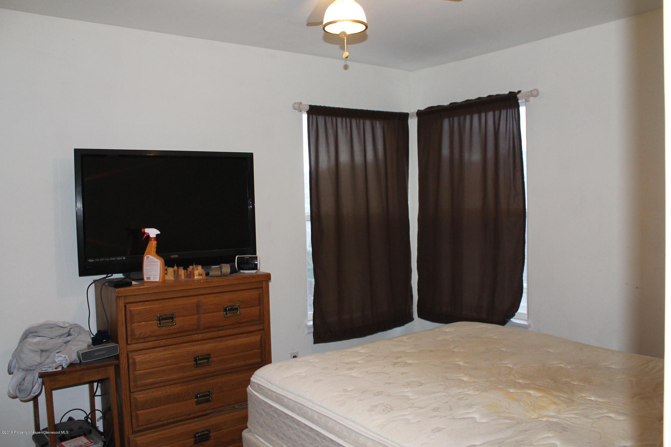 402 Columbine Court Rifle, CO 81650 - Photo 10 of 19 a bedroom with a bed and a dresser