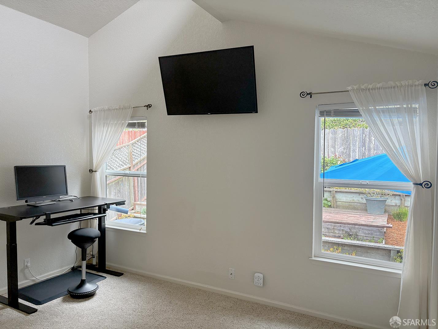 472 Copeland Street Pacifica, CA 94044 - Photo 14 of 31 a view of a workspace with furniture and a flat screen tv