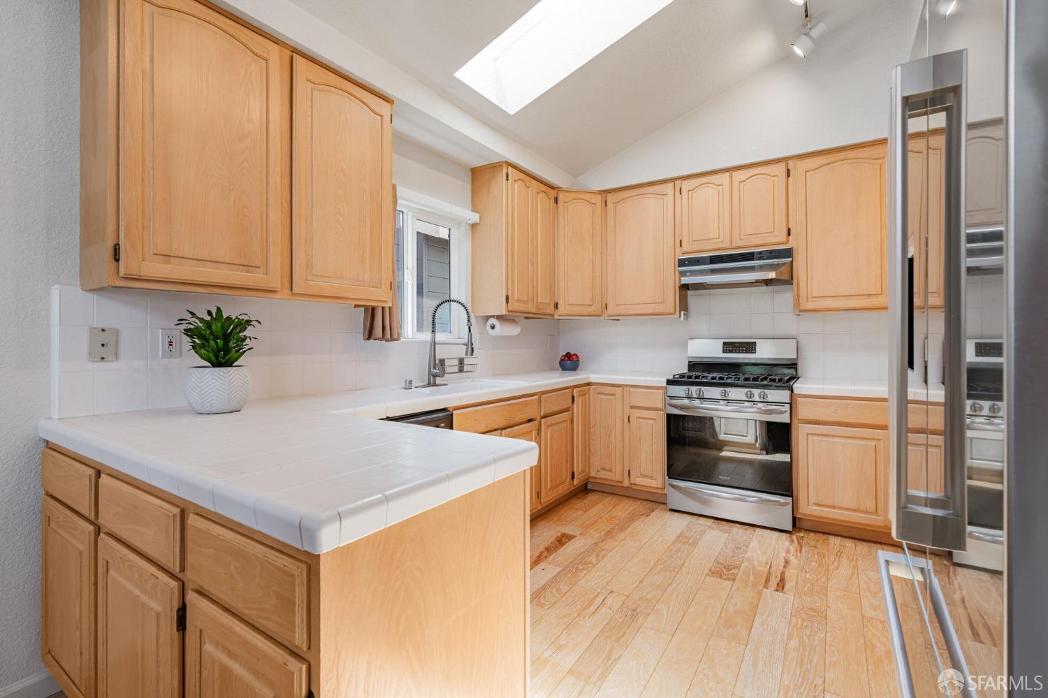 472 Copeland Street Pacifica, CA 94044 - Photo 8 of 31 a kitchen with stainless steel appliances white cabinets and a counter top space