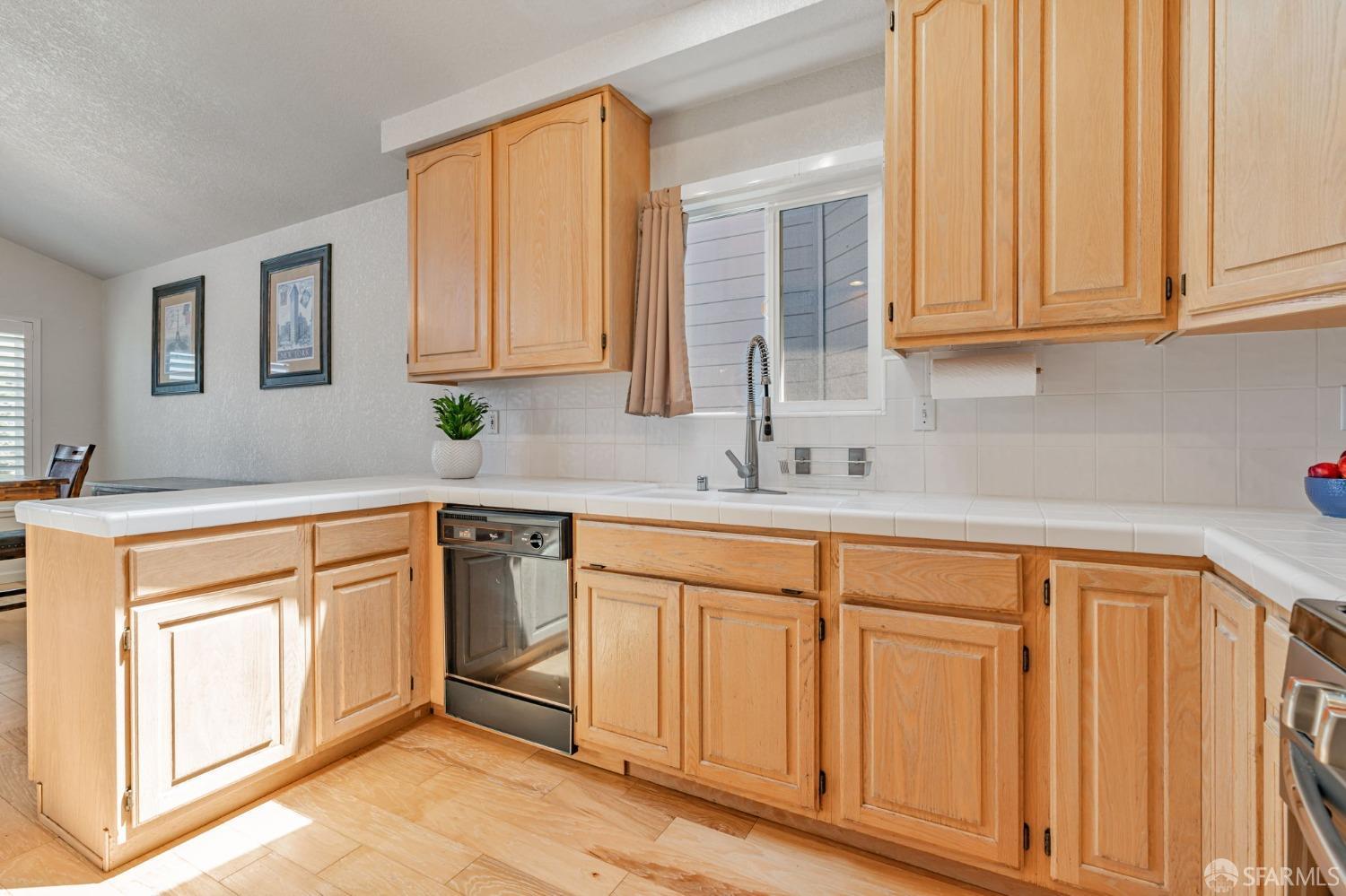 472 Copeland Street Pacifica, CA 94044 - Photo 10 of 31 a kitchen with granite countertop white cabinets and sink