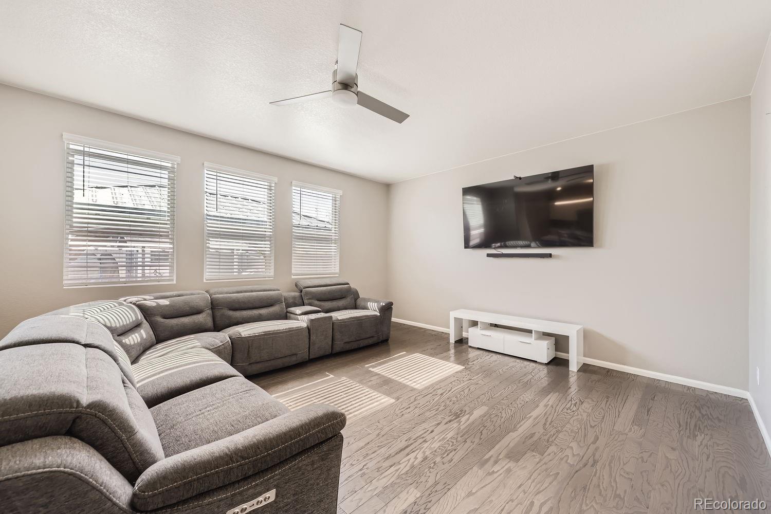 6808 Morrison Drive Frederick, CO 80530 - Photo 12 of 28 a living room with furniture and a flat screen tv