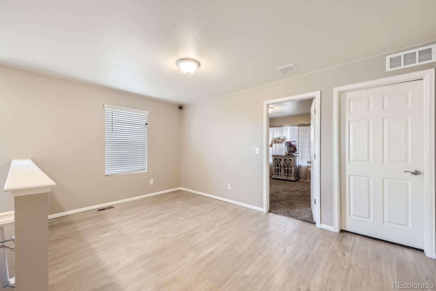 6808 Morrison Drive Frederick, CO 80530 - Photo 14 of 28 a view of a room with wooden floor closet and windows