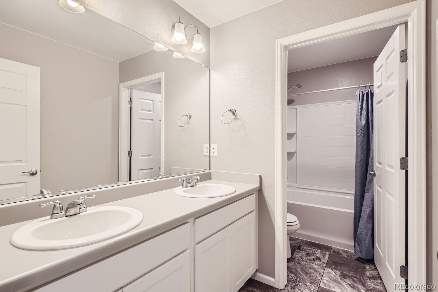 6808 Morrison Drive Frederick, CO 80530 - Photo 15 of 28 a bathroom with a sink a toilet and shower
