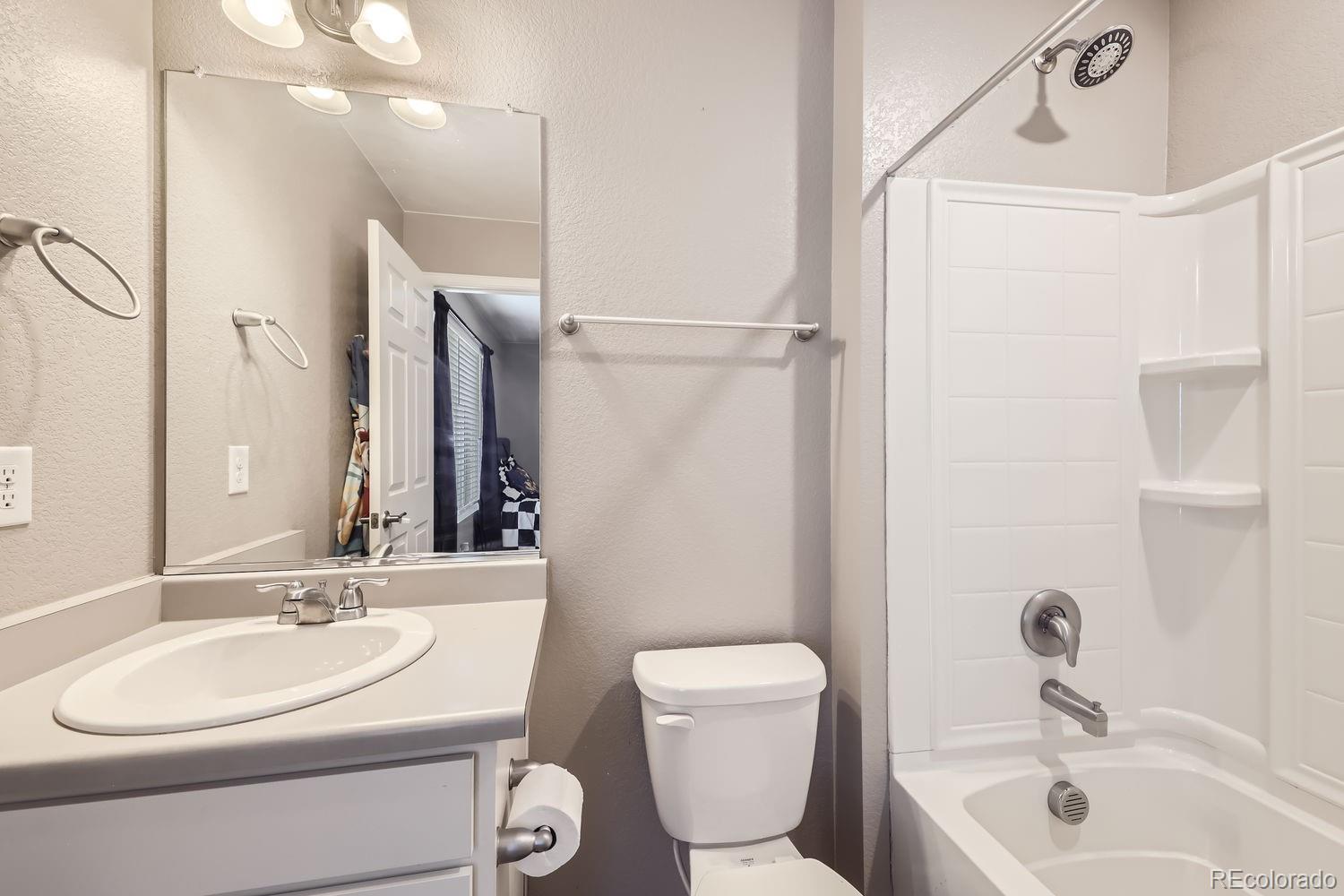 6808 Morrison Drive Frederick, CO 80530 - Photo 16 of 28 a bathroom with a sink toilet and shower