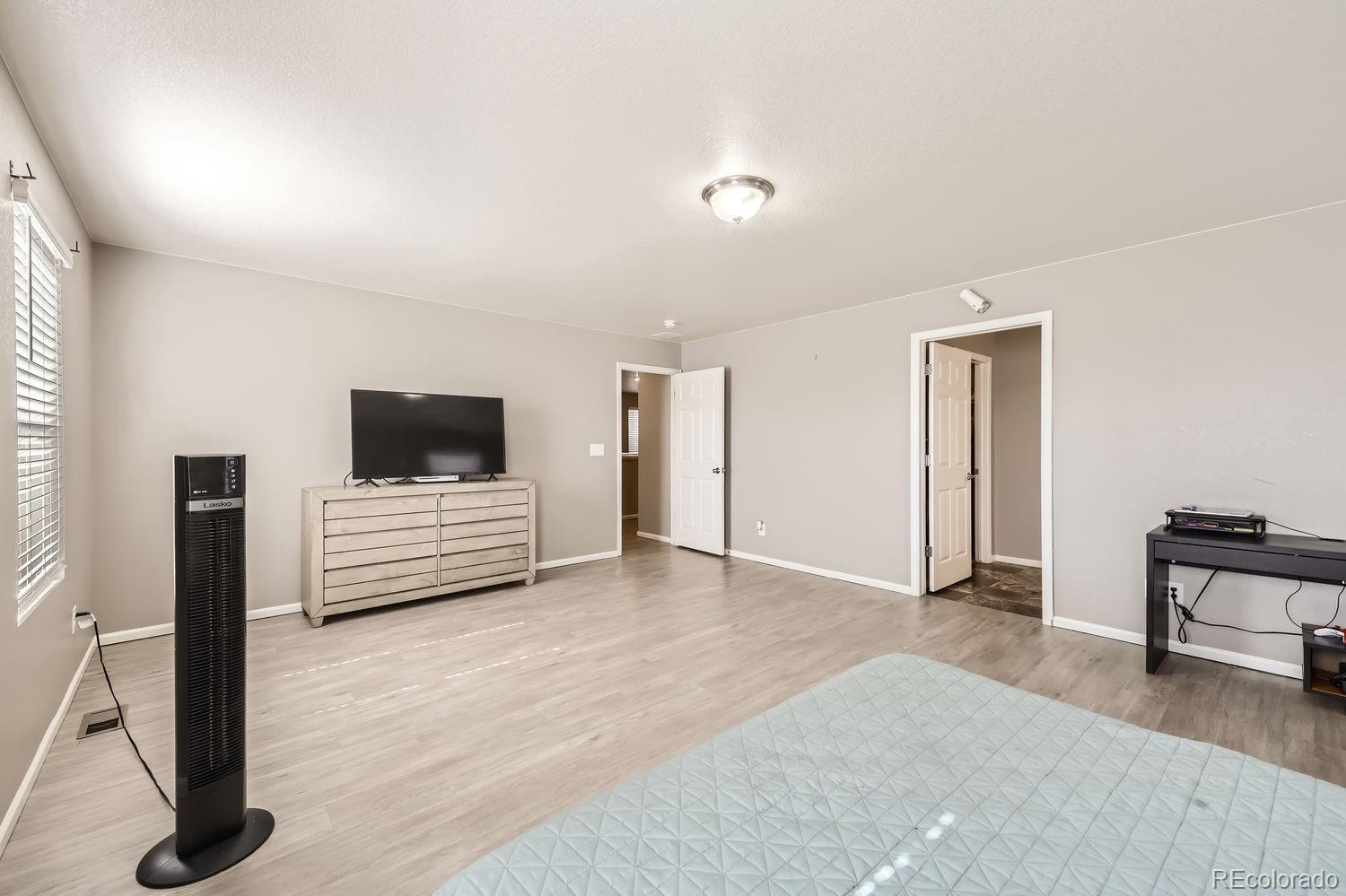 6808 Morrison Drive Frederick, CO 80530 - Photo 23 of 28 a living room with furniture and a flat screen tv