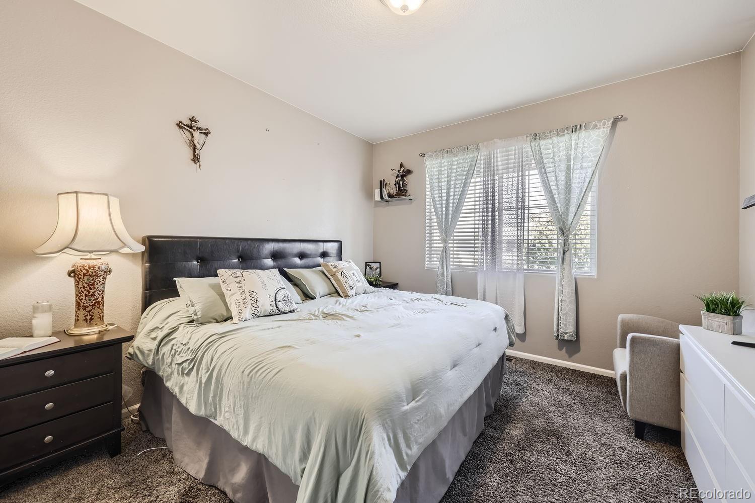 6808 Morrison Drive Frederick, CO 80530 - Photo 25 of 28 a bedroom with a bed and wooden floor