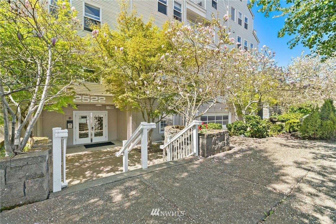 a view of a patio with table and chairs and potted plants