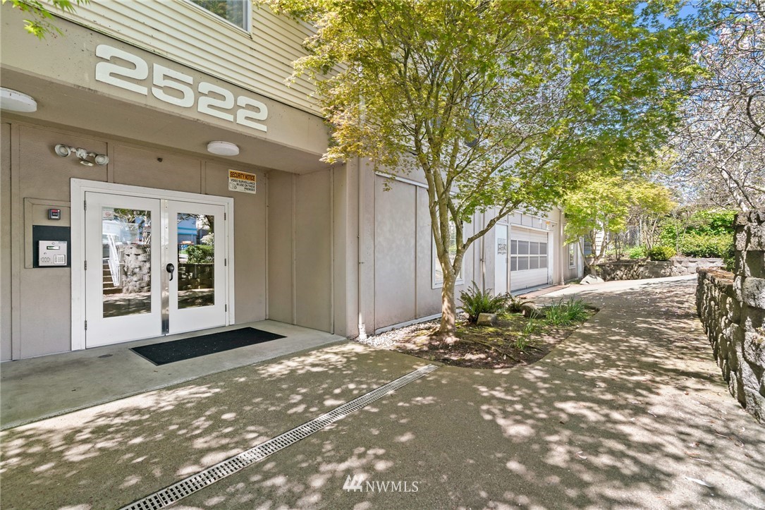 2522 Rucker Avenue, Unit 407 Everett, WA 98201 - Photo 2 of 30 a view of a house with a yard and tree
