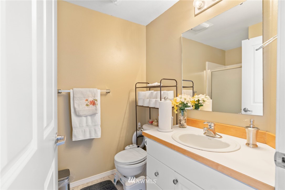 2522 Rucker Avenue, Unit 407 Everett, WA 98201 - Photo 12 of 30 a bathroom with a sink toilet vanity and mirror