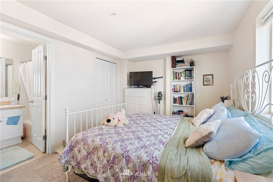 2522 Rucker Avenue, Unit 407 Everett, WA 98201 - Photo 13 of 30 a bedroom with a bed and a flat screen tv
