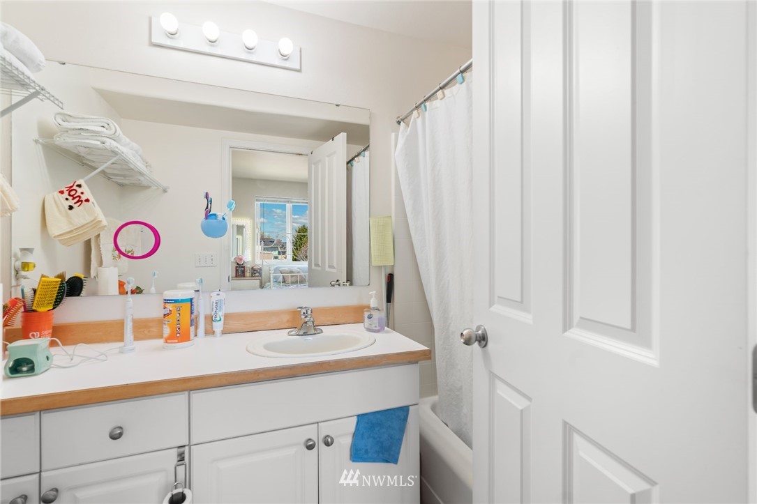 2522 Rucker Avenue, Unit 407 Everett, WA 98201 - Photo 16 of 30 walk in a bathroom with a sink and a mirror