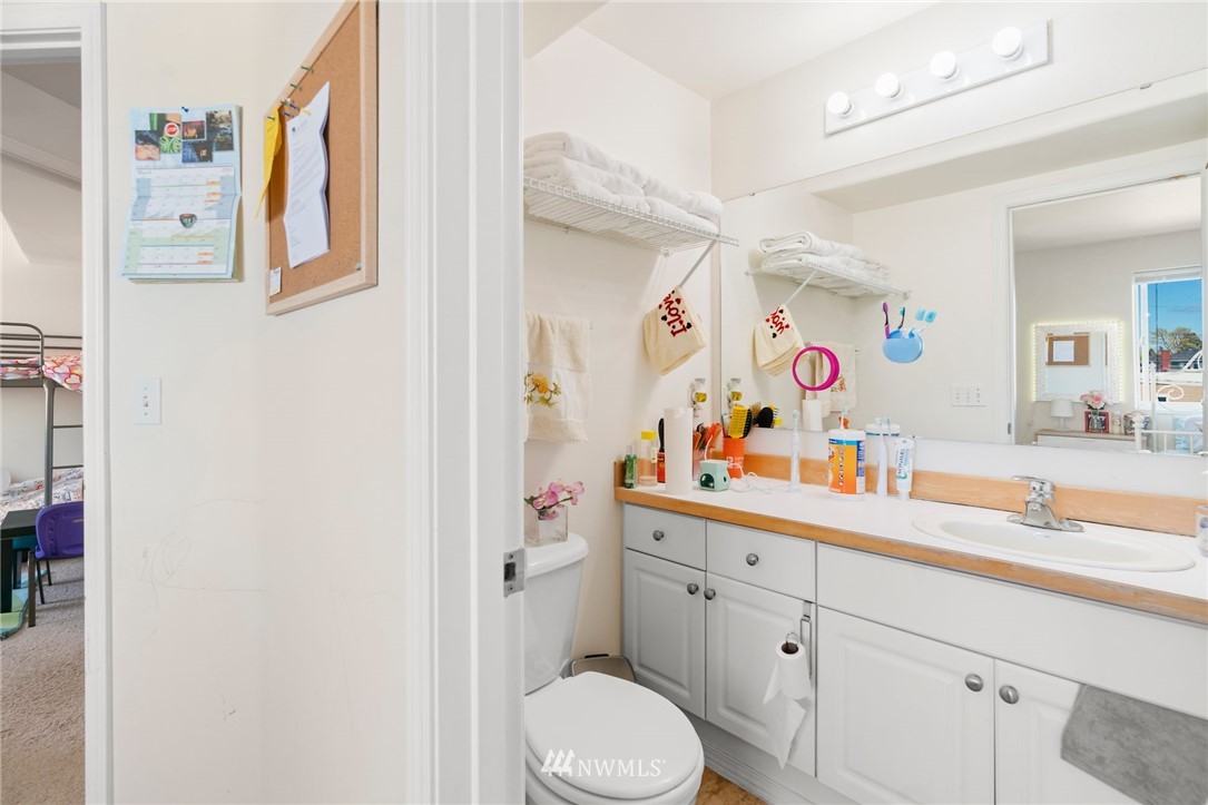 2522 Rucker Avenue, Unit 407 Everett, WA 98201 - Photo 17 of 30 a bathroom with a sink a toilet and a mirror