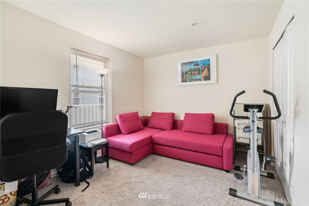 2522 Rucker Avenue, Unit 407 Everett, WA 98201 - Photo 20 of 30 a living room with furniture a flat screen tv and a window
